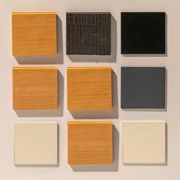 Material samples of wood, laminate, and glass finishes used in custom walk-in closet cabinets