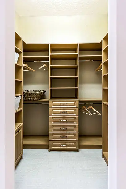 Smart storage solutions in custom closet systems for small walk-in closets