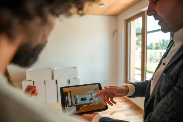 A professional designer showing a 3D custom closet rendering to a homeowner during a consultation