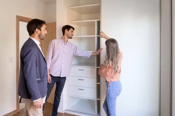 Closet builders near me at KBR Closet review 3D custom closet systems with clients in Fairfax showrooms.