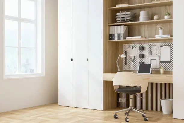 A guest room closet doubling as a home office with foldable desks, adjustable shelves, and stylish finishes.
