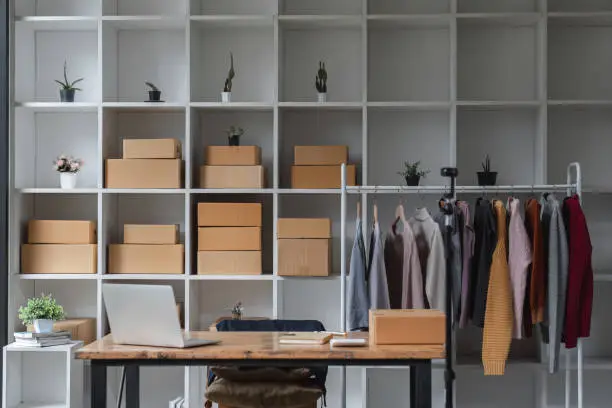 A walk-in closet with organized inventory, bins, and shipping materials, tailored for an e-commerce business.