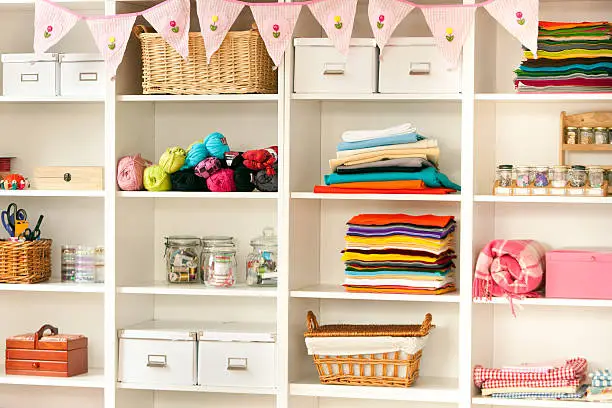 A vibrant hobby room closet with organized shelves, drawers, and pegboards for craft supplies, instruments, or sports gear.