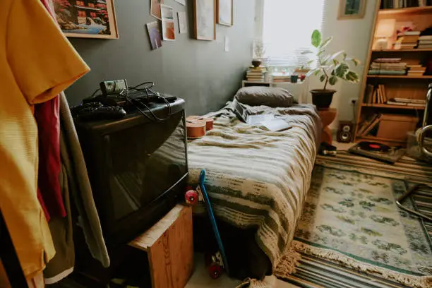 Renters cluttered small apartment bedroom with limited storage