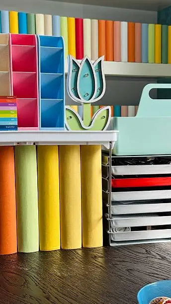 A craft room closet with organized fabrics, paper, and tools, designed for efficient storage and creative flow.