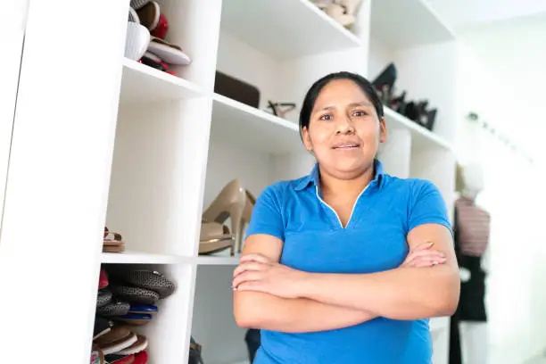 A homeowner in an organized custom closet, showcasing stress-free benefits of installation