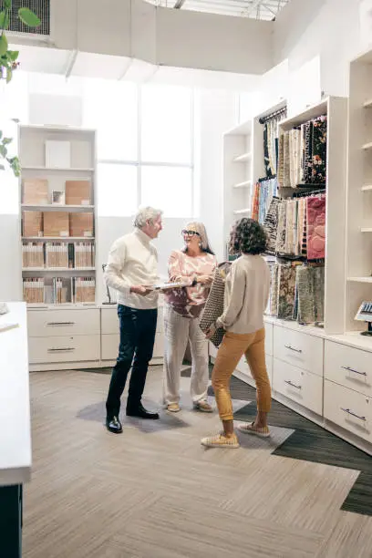 A consultation in a showroom with a designer discussing pet-friendly closet designs using 3D rendering