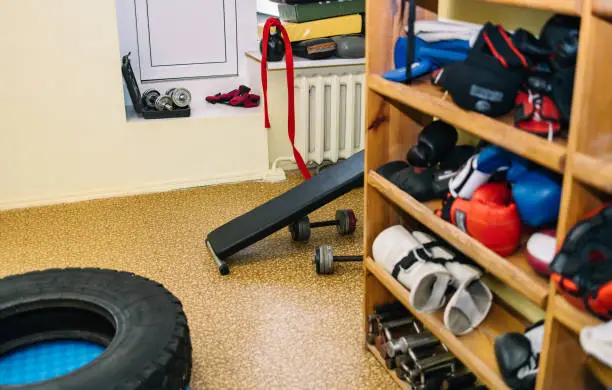 Custom closet systems for home gym storage with cluttered gear