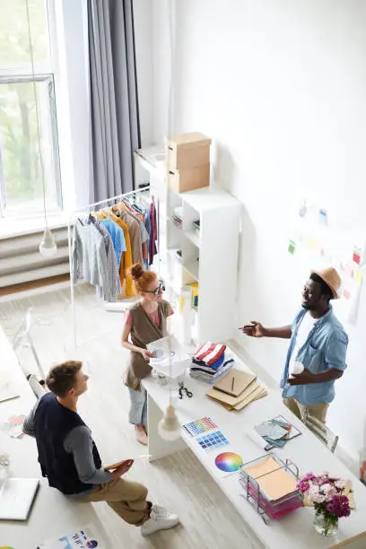 A consultation in a showroom with a designer discussing home office closet designs using 3D renderings