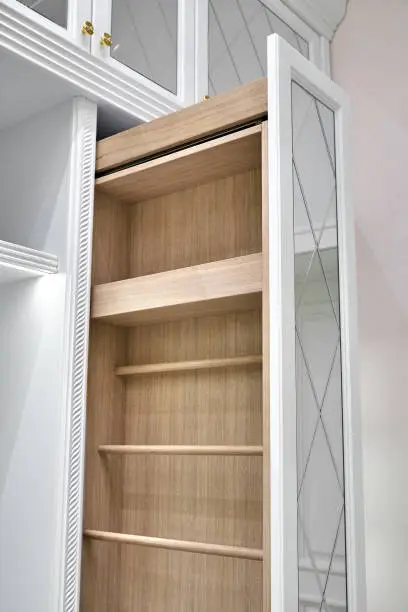 A close-up of a reach-in closet with bi-fold doors, vertical shelving, and pull-out organizers, designed for efficiency