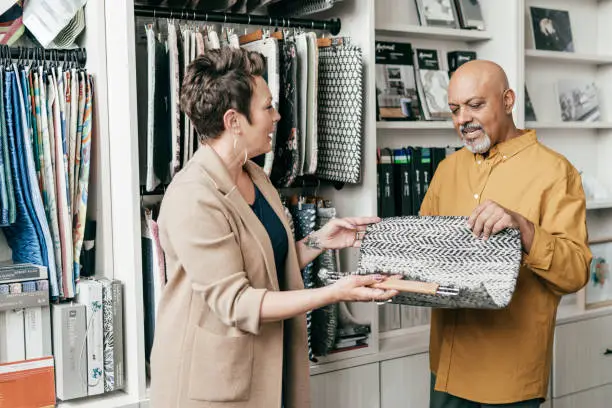 A consultation in a showroom with a designer discussing luxury closet designs using 3D renderings