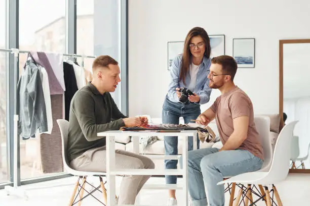 A consultation in a showroom with a designer discussing custom wardrobe designs using 3D renderings