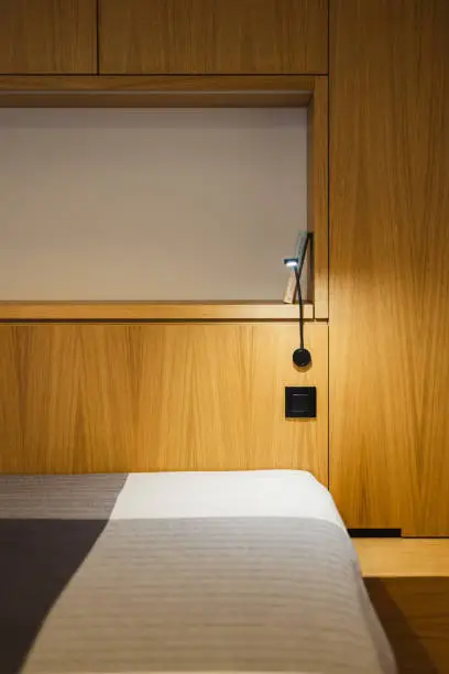 A close-up of a Murphy Bed with premium wood finishes, integrated lighting, and foldable desk, designed for functionality