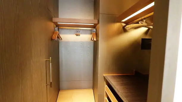 A luxury walk-in closet for a couple, with dual zones, a central island, and mirrored panels for shared use
