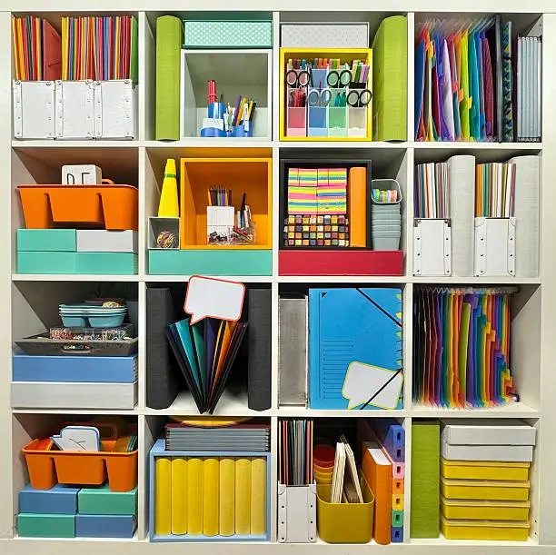 A home office closet for a creative professional with organized bins, shelves, and vibrant finishes for supplies